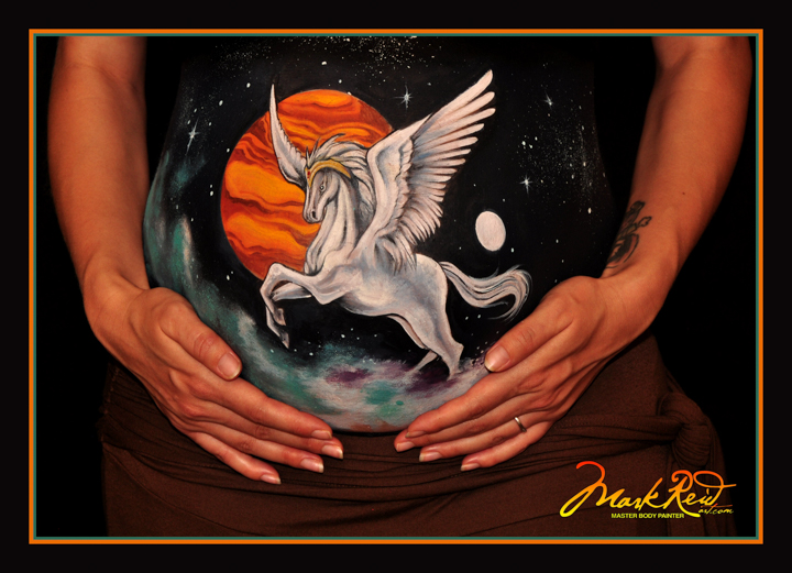 close up picture of a pregnant womans's belly featuring a pegasus horse and and orange moon backround